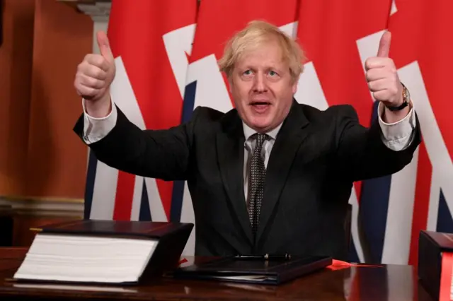 Boris Johnson gives a thumbs up after signing the Brexit trade deal with the EU on 30 December, 2020