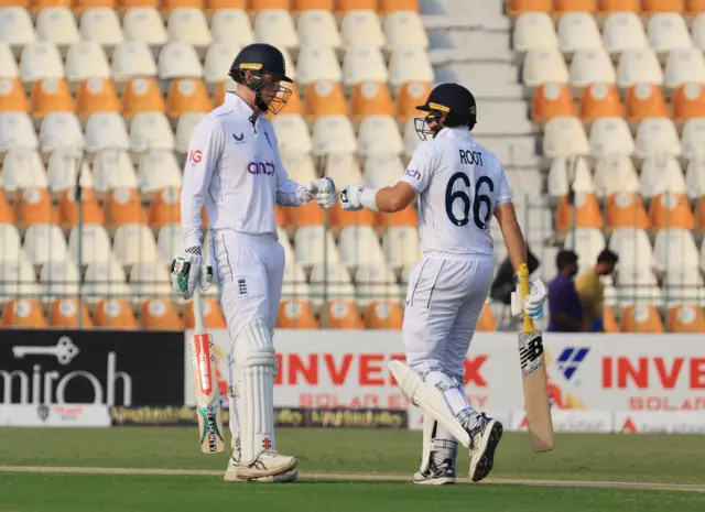 Joe Root and Zak Crawley punch gloves