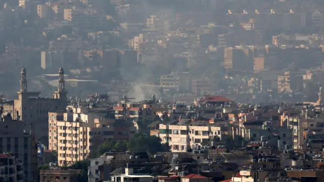 Smoke rises over buildings in Dahiyeh in Beirut's southern suburbs.