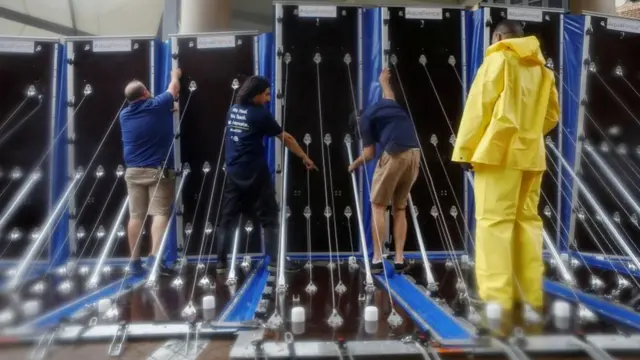 Four people setting up a barrier in Tampa General Hospital.