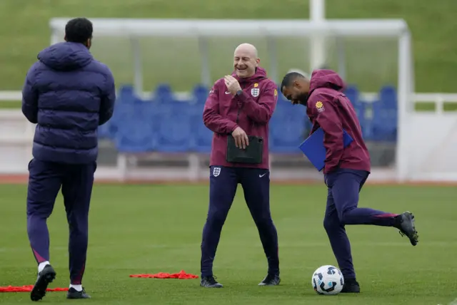 Interim manager Lee Carsley and coach Ashley Cole smiling during England training