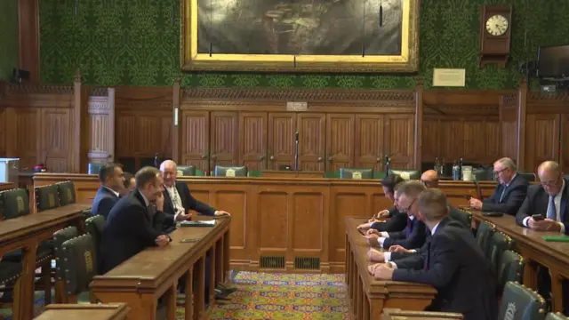 Tory MPs sit as part of the 1922 committee waiting for its chair to enter