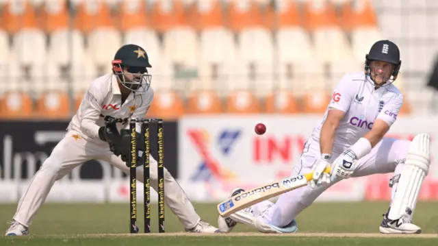 Joe Root reverse sweeps for runs during day three of the first Test between Pakistan and England