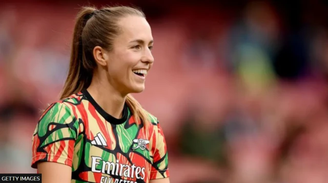 Arsenal's Lia Walti smiling while warming up