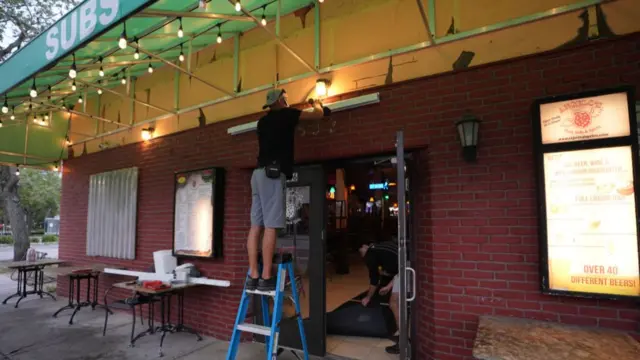 Workers board up a business ahead of Hurricane Milton's expected landfall in St. Petersburg, Florida, US,