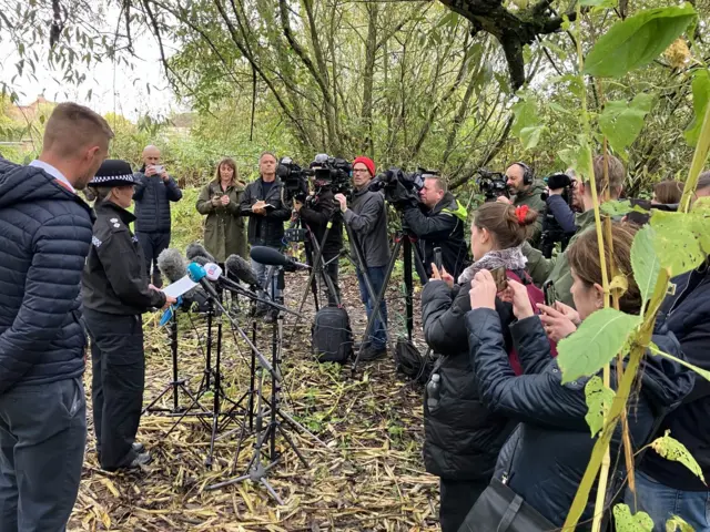 Reporters listening to press conference