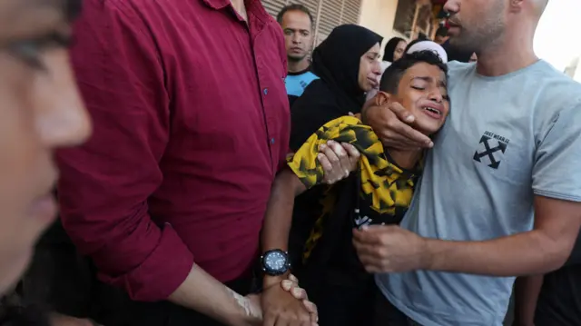 A boy mourns in Deir Al-Balah, Gaza