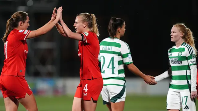 Twente and Celtic players high-five their team-mates after their Women's Champions League game