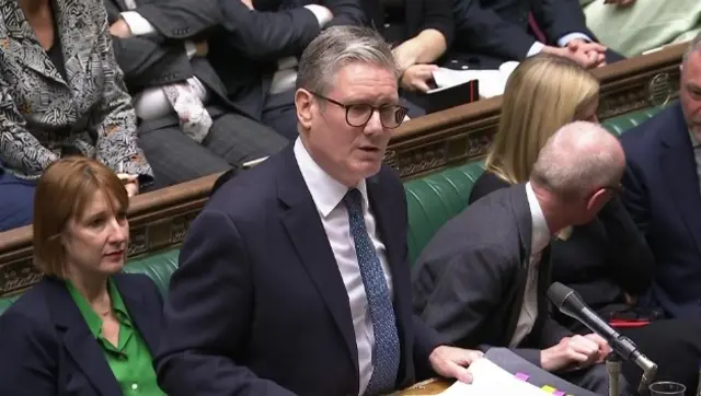 Keir Starmer answers questions during PMQs in dark blue suit