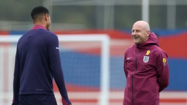 Interim manager Lee Carsley talks to Levi Colwill at England training