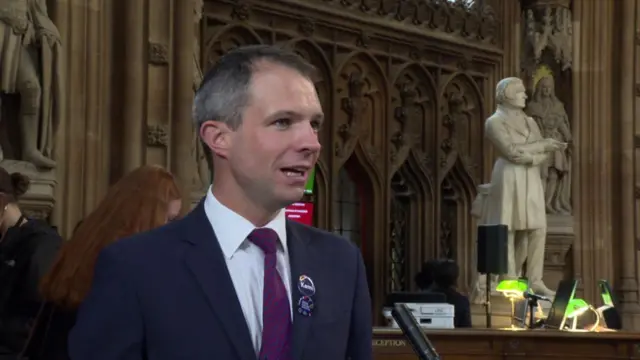 Conservative MP Andrew Bowie speaking in Westminster's central lobby