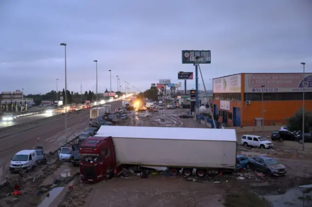 Cars and trucks are among the debris swept up in recent flash flooding along the V-31 highway near the municipality of Massanassa