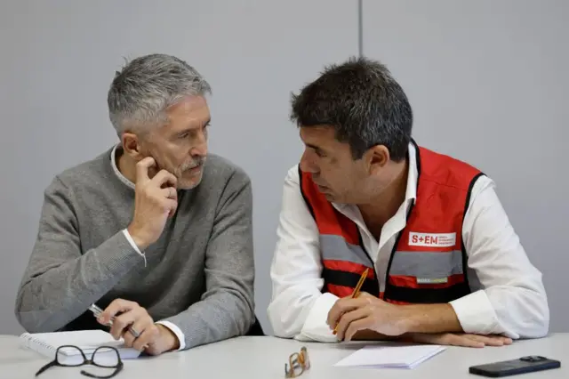 Regional President of Valencia, Carlos Mazon (R) chats with Spanish Interior Minister, Fernando Grande-Marlaska (L), at Emergency Control Centre