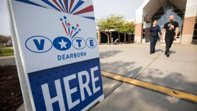 People leave a polling place where voters are casting their ballots during Michigan's early voting period on October 29, 2024 in Dearborn, Michigan.