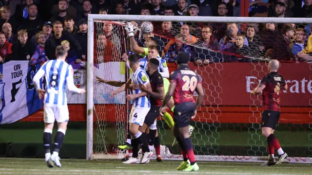 Goalkeeper Jasbir Singh of Tamworth fails to claim the ball