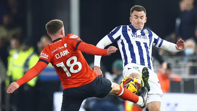 Jordan Clark battles with Jed Wallace for the ball