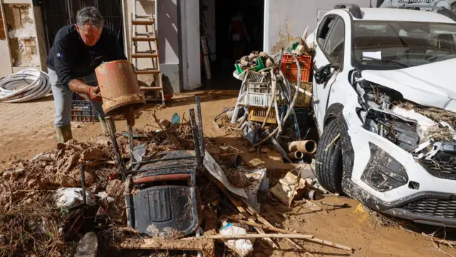 A local works to clean his house in the flood-hit city of Chiva, near Valencia, Spain, 31 October 2024