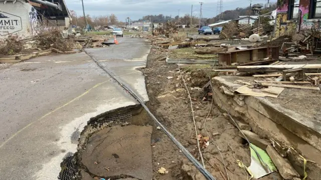 The road in North Carolina is seen with major cracks in it and is torn up