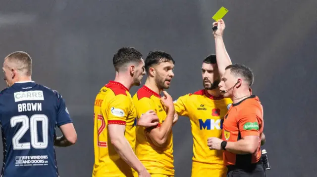 KIRKCALDY, SCOTLAND - NOVEMBER 01: Ayr's Connor McLennan is shown a yellow card by referee Lloyd Wilson during a William Hill Championship match between Raith Rovers and Ayr United at Stark's Park, on November 01, 2024, in Kirkcaldy, Scotland. (Photo by Ross Parker / SNS Group)