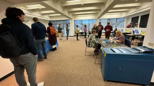 People queue to vote at an election centre