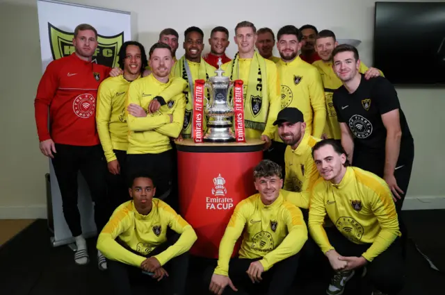 Players from Harborough Town pose for a photograph with the Emirates FA Cup Trophy