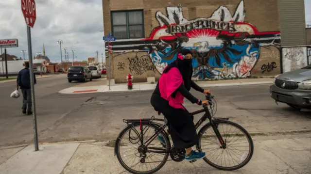 A girl rides home from her class on the Quran in Hamtramck, Michigan