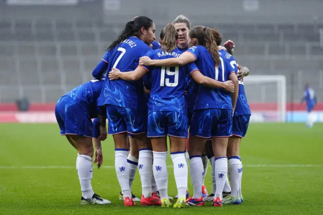 Chelsea huddle together as they celebrate a goal