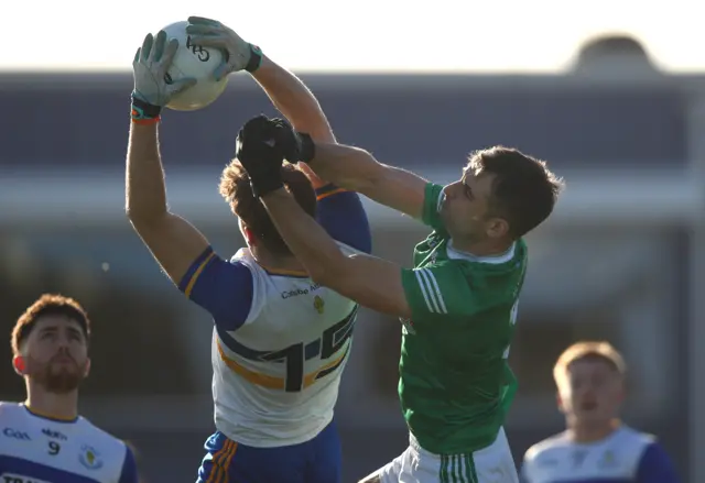 Errigal Ciaran's Odhran Robinson outfields Cargin's Justin Crozier at Corrigan Park