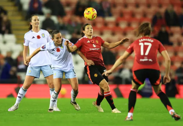 Williams tries to bring the ball out of the air with a defender at her back