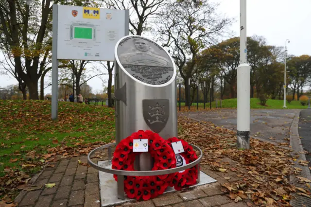 Poppy wreaths at a memorial outside of the The MKM home stadium of Hull City