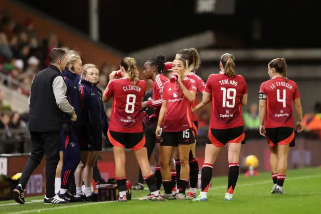 United players take on drinks during a stop in play