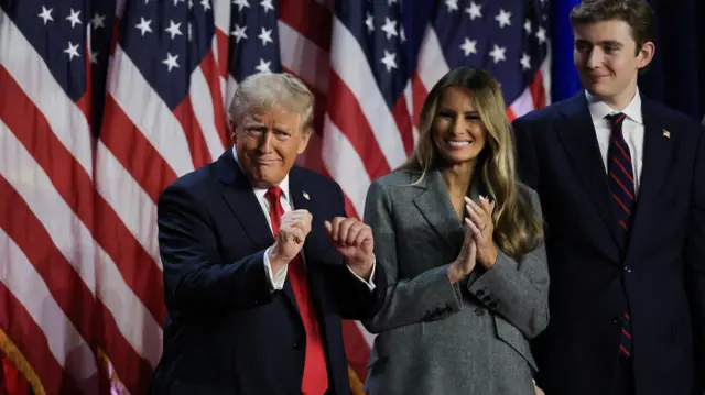 Republican presidential nominee and former U.S. President Donald Trump dances accompanied by Melania Trump and Barron Trump, after speaking following early results from the 2024 U.S. presidential election