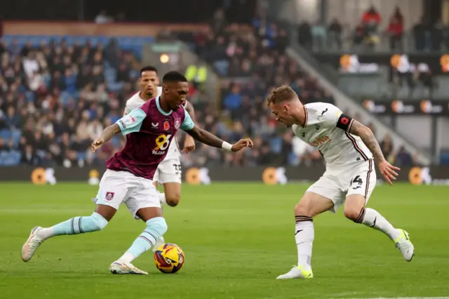 Burnley's Jaidon Anthony takes on Swansea City's Josh Tymon