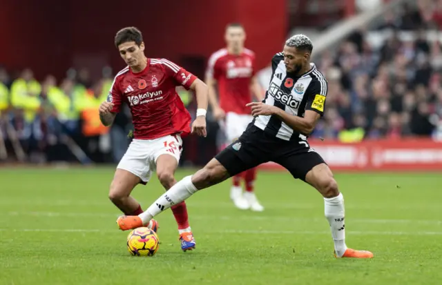 Joelinton shields the ball with his body