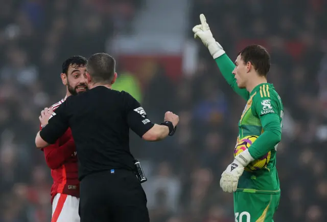 Bruno Fernandes talks to referee