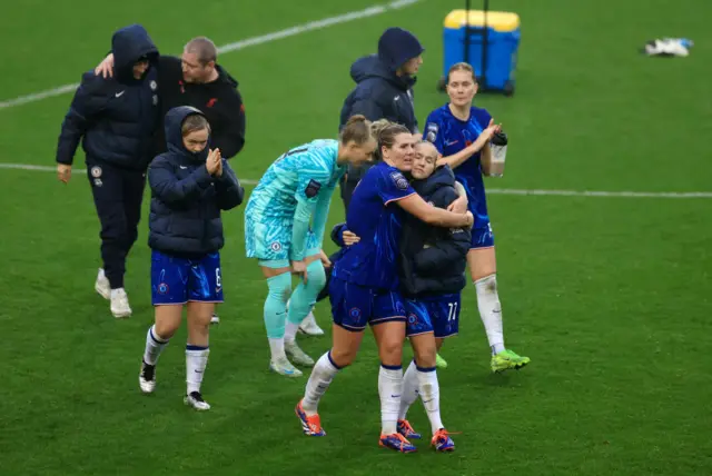 Chelsea players celebrate their win on the pitch at full time