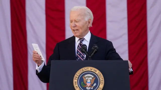 U.S. President Joe Biden reads the number of U.S. casualties in Iraq and Afghanistan during the National Veterans Day Observance in Arlington National Cemetery in Arlington, Virginia, U.S