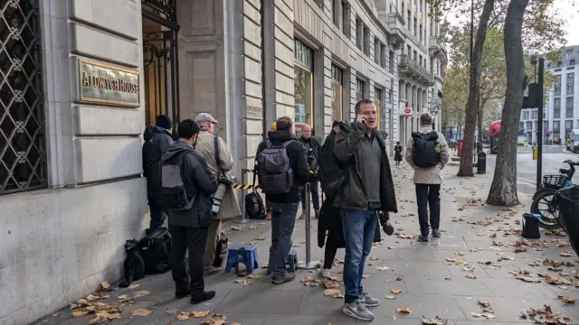 Journalists congregate in front of Aldwych House in Holborn, London