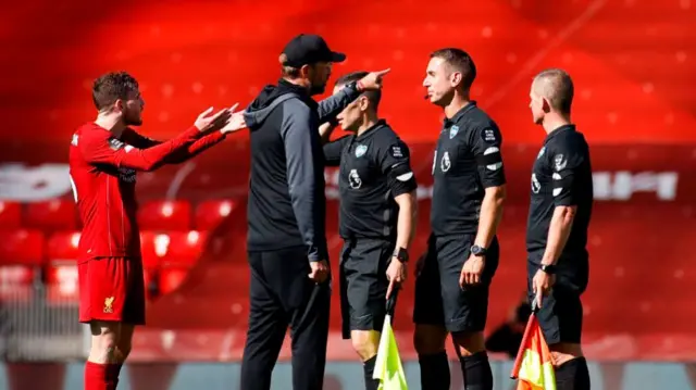 Jurgen Klopp speaks to David Coote after the final whistle.