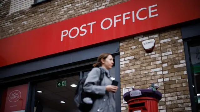 A person walks past a Post Office branch in east London