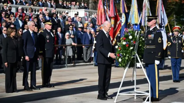 US President Joe Biden lays a wreath at The Tomb of the Unknown Soldier in Arlington National Cemetery to mark Veterans Day as Vice President Kamala Harris (L) and Veterans' Affairs Secretary Dennis McDonough (2nd L) look on on November 11, 2024 in Arlington, Virginia.