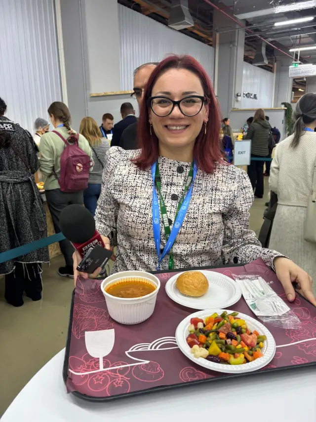 Woman holding tray of food
