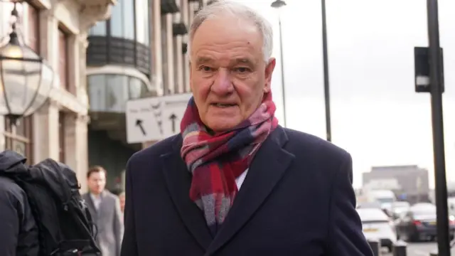 Former Post Office Chair Henry Staunton walks near the Houses of Parliament