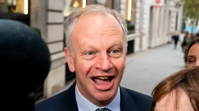 Nick Read smiling wearing a suit