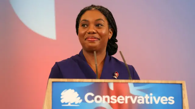 Kemi Badenoch speaks on stage