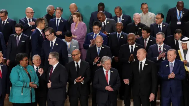 Leaders gather for a family photo in front of the COP29 and UNFCCC logo