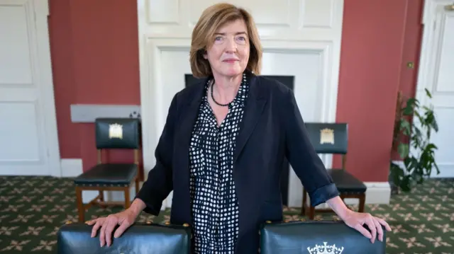 Sue Gray poses for a photo next to chairs marked with the crowned portcullis - a symbol of Parliament