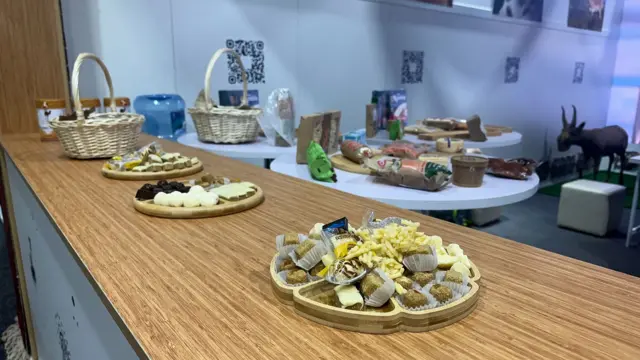 Food sits on small plates on wooden counter