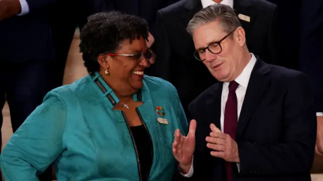 arbadian Prime Minister Mia Mottley and British Prime Minister Keir Starmer interact as they prepare to pose for a family photo on day two of the UNFCCC COP29 Climate Conference at Baku Stadium on November 12, 2024 in Baku