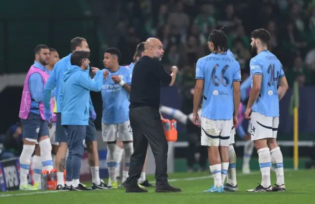 Pep Guardiola, manager of Manchester City, gives instructions to the team